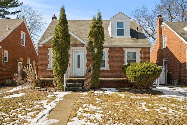 view of front of home with entry steps and brick siding