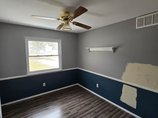 unfurnished room with a ceiling fan, wood finished floors, visible vents, and baseboards