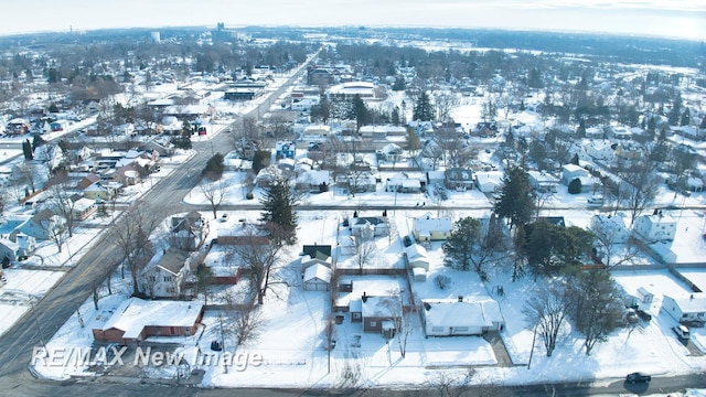 snowy aerial view with a residential view