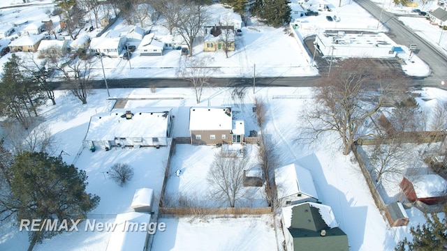 snowy aerial view with a residential view