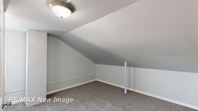 bonus room featuring lofted ceiling, carpet, and baseboards