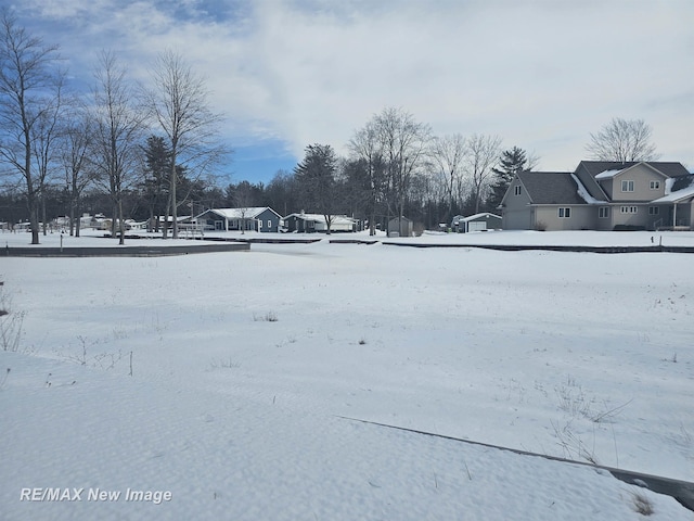 yard covered in snow with a garage