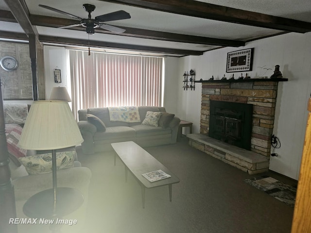 living room with ceiling fan, beam ceiling, and a stone fireplace