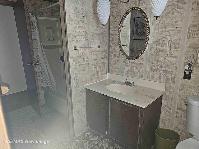 bathroom with curtained shower, tile patterned flooring, vanity, and toilet