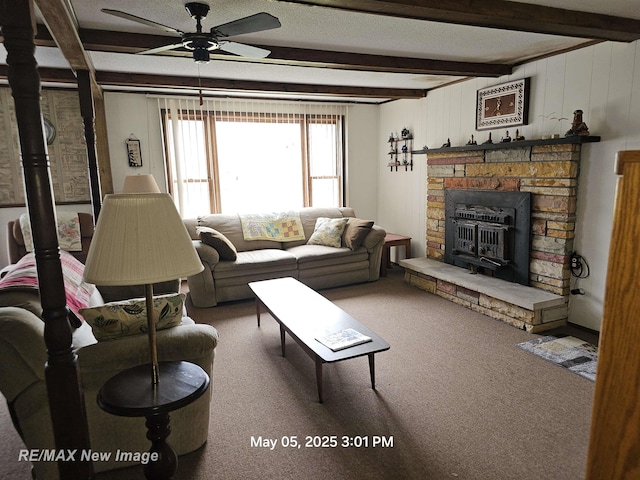 5243 Martin Rd, Beaverton, MI 48612 - carpeted living room featuring a ceiling fan, beamed ceiling, and a stone fireplace