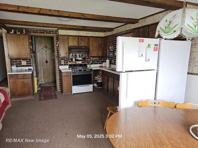 5243 Martin Rd, Beaverton, MI 48612 - kitchen with white appliances, under cabinet range hood, light countertops, backsplash, and beamed ceiling