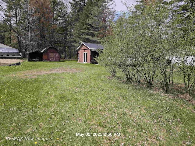 5243 Martin Rd, Beaverton, MI 48612 - view of grassy yard featuring a storage unit