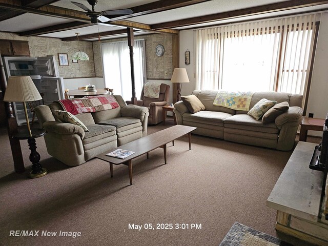 5243 Martin Rd, Beaverton, MI 48612 - carpeted living room with ceiling fan, plenty of natural light, beamed ceiling, wainscoting, and wallpapered walls