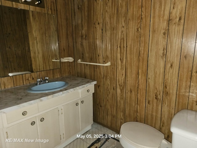 5243 Martin Rd, Beaverton, MI 48612 - bathroom featuring wood walls and vanity