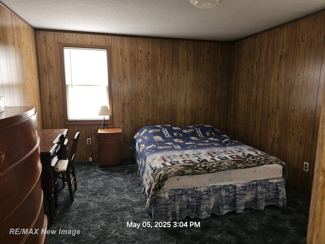 5243 Martin Rd, Beaverton, MI 48612 - bedroom featuring dark colored carpet, wood walls, and a textured ceiling