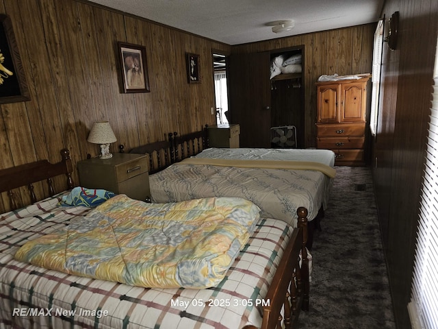 5243 Martin Rd, Beaverton, MI 48612 - bedroom with wooden walls, carpet, a textured ceiling, and crown molding