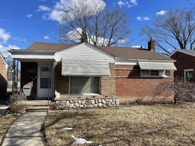 view of front of house featuring roof with shingles, brick siding, and a chimney