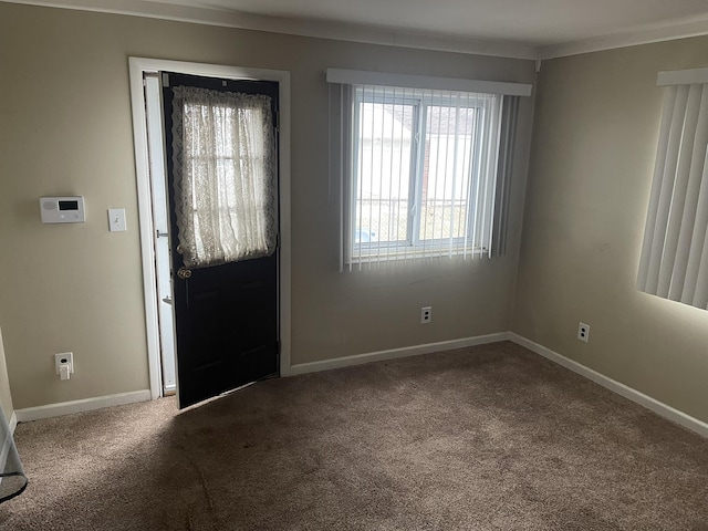 carpeted foyer entrance featuring baseboards