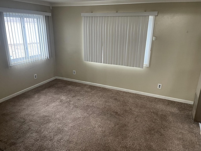 unfurnished room with carpet and baseboards