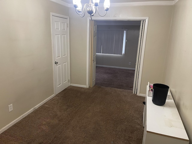 corridor featuring a chandelier, dark carpet, and baseboards