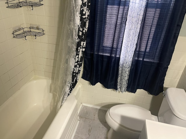 full bathroom with shower / bath combo, tile walls, and toilet