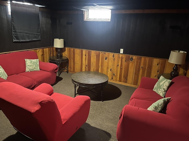 carpeted living room with wainscoting and wood walls