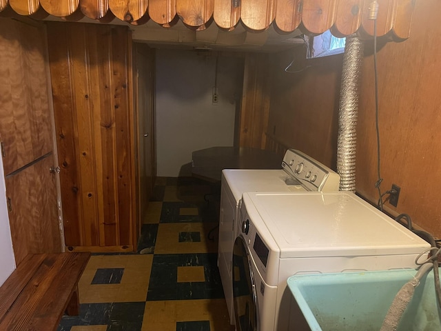 laundry room featuring laundry area, a sink, washing machine and clothes dryer, and tile patterned floors