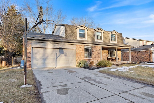 view of front of home with brick siding, a shingled roof, covered porch, an attached garage, and driveway