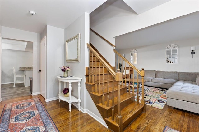 stairway featuring baseboards and wood finished floors