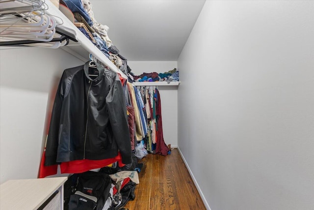 spacious closet with dark wood-style floors