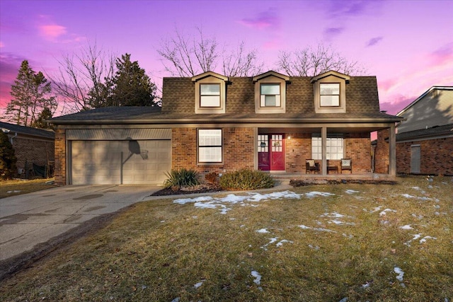 view of front facade featuring a garage, covered porch, brick siding, and roof with shingles