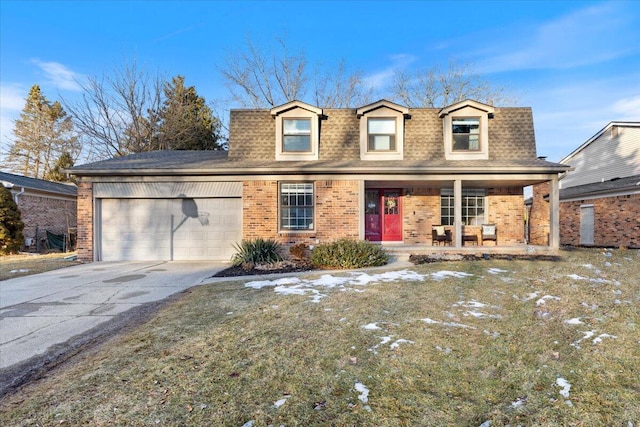 view of front of house with an attached garage, covered porch, brick siding, driveway, and roof with shingles