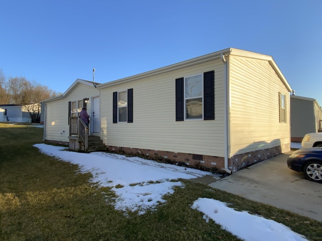 manufactured / mobile home with entry steps, a yard, and crawl space