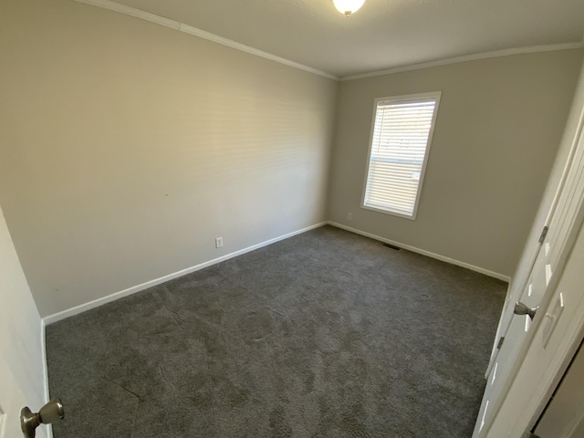 unfurnished bedroom featuring ornamental molding, dark colored carpet, visible vents, and baseboards