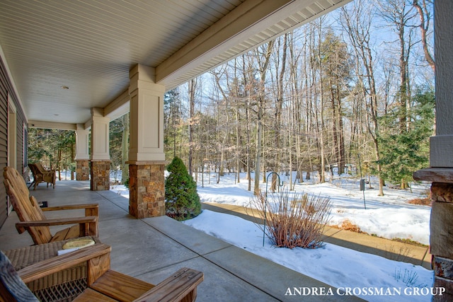 snow covered patio with covered porch