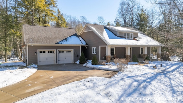 view of front of home with a garage, covered porch, and driveway