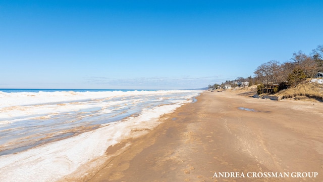 exterior space with a water view and a beach view