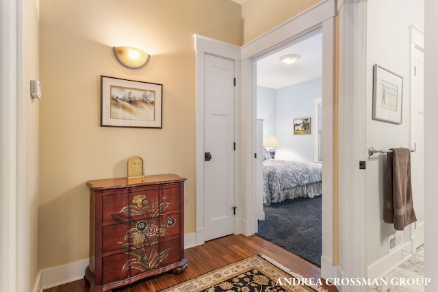 hall featuring wood finished floors and baseboards