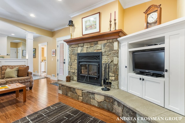 living area with decorative columns, recessed lighting, light wood-style flooring, ornamental molding, and baseboards