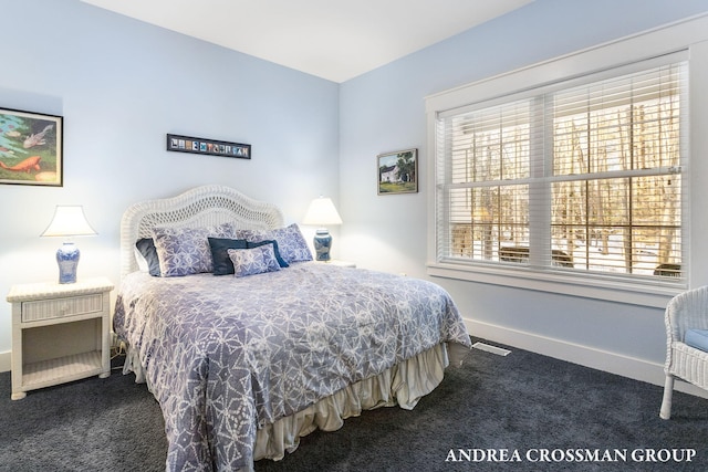 carpeted bedroom with visible vents and baseboards