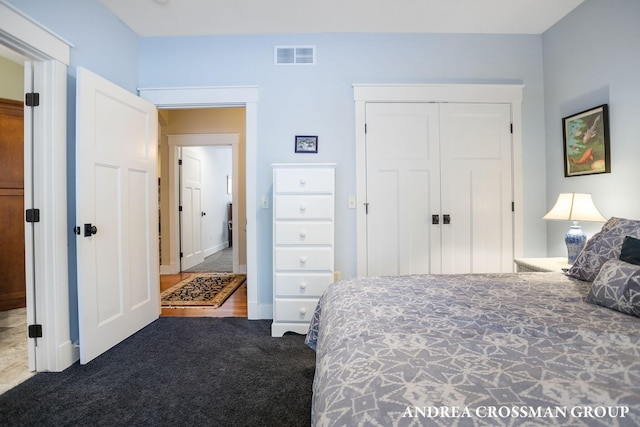 bedroom featuring a closet, carpet, and visible vents