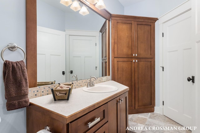 bathroom with tasteful backsplash and vanity