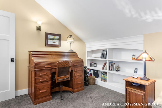 office space featuring vaulted ceiling and dark colored carpet