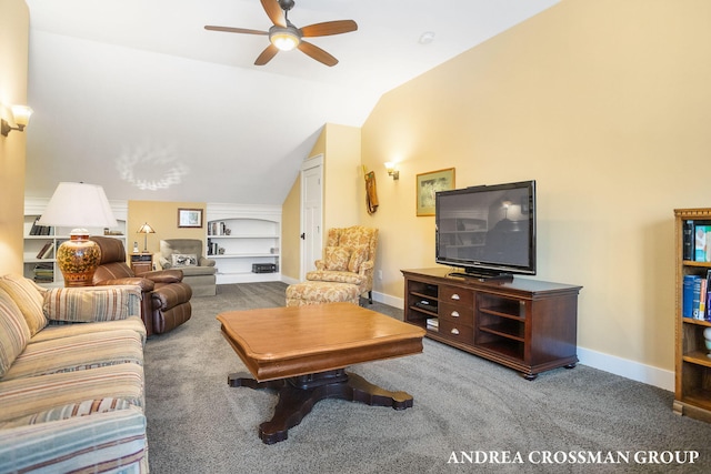 carpeted living room with ceiling fan, baseboards, built in features, and vaulted ceiling