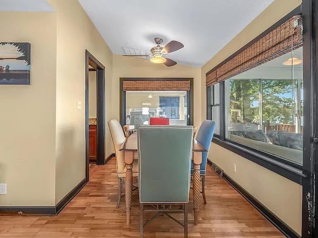 dining area with ceiling fan, baseboards, and wood finished floors