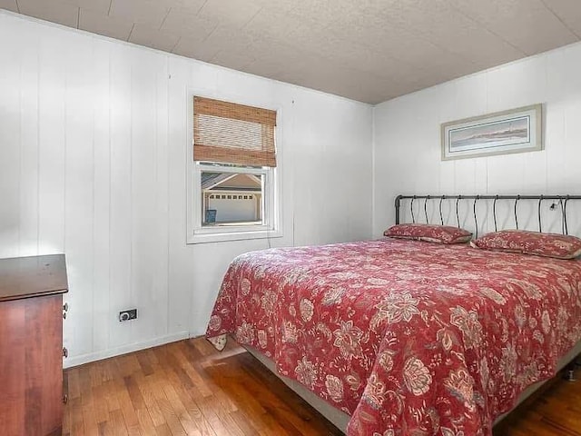 bedroom featuring dark wood finished floors