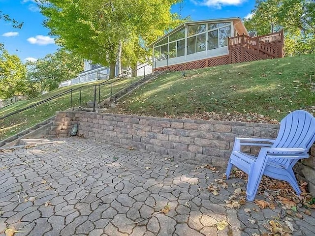 view of patio / terrace with a sunroom and fence