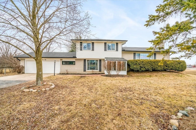 split level home with a garage, concrete driveway, and brick siding