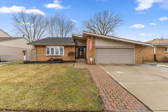 view of front of home with driveway, brick siding, an attached garage, and a front yard