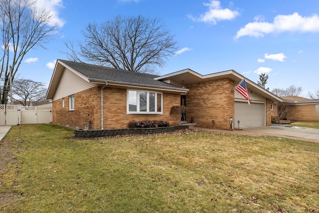 view of front of property featuring driveway, brick siding, fence, and a gate