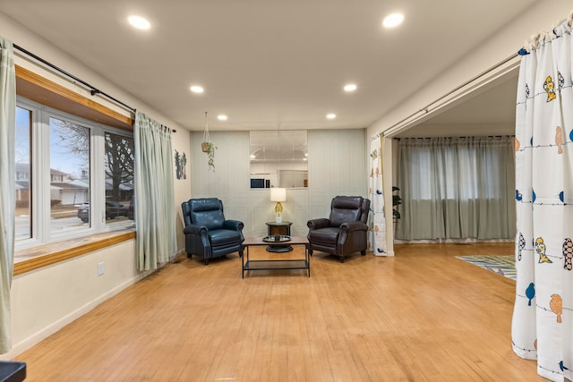 sitting room featuring light wood finished floors, baseboards, and recessed lighting