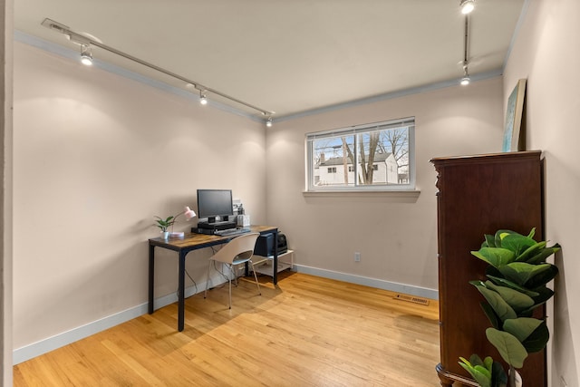 office area with visible vents, track lighting, baseboards, and wood finished floors