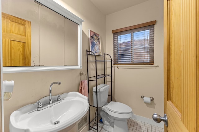 bathroom featuring toilet, visible vents, and baseboards