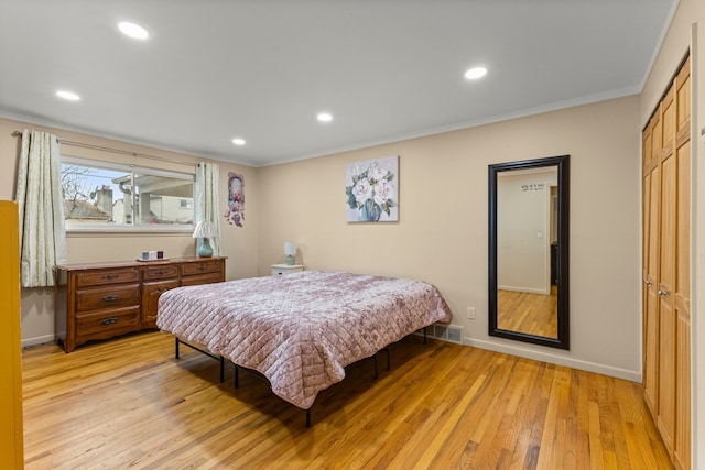 bedroom with recessed lighting, light wood-style flooring, and baseboards