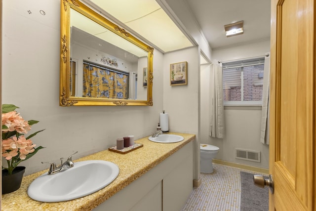 full bath featuring ornamental molding, visible vents, a sink, and toilet